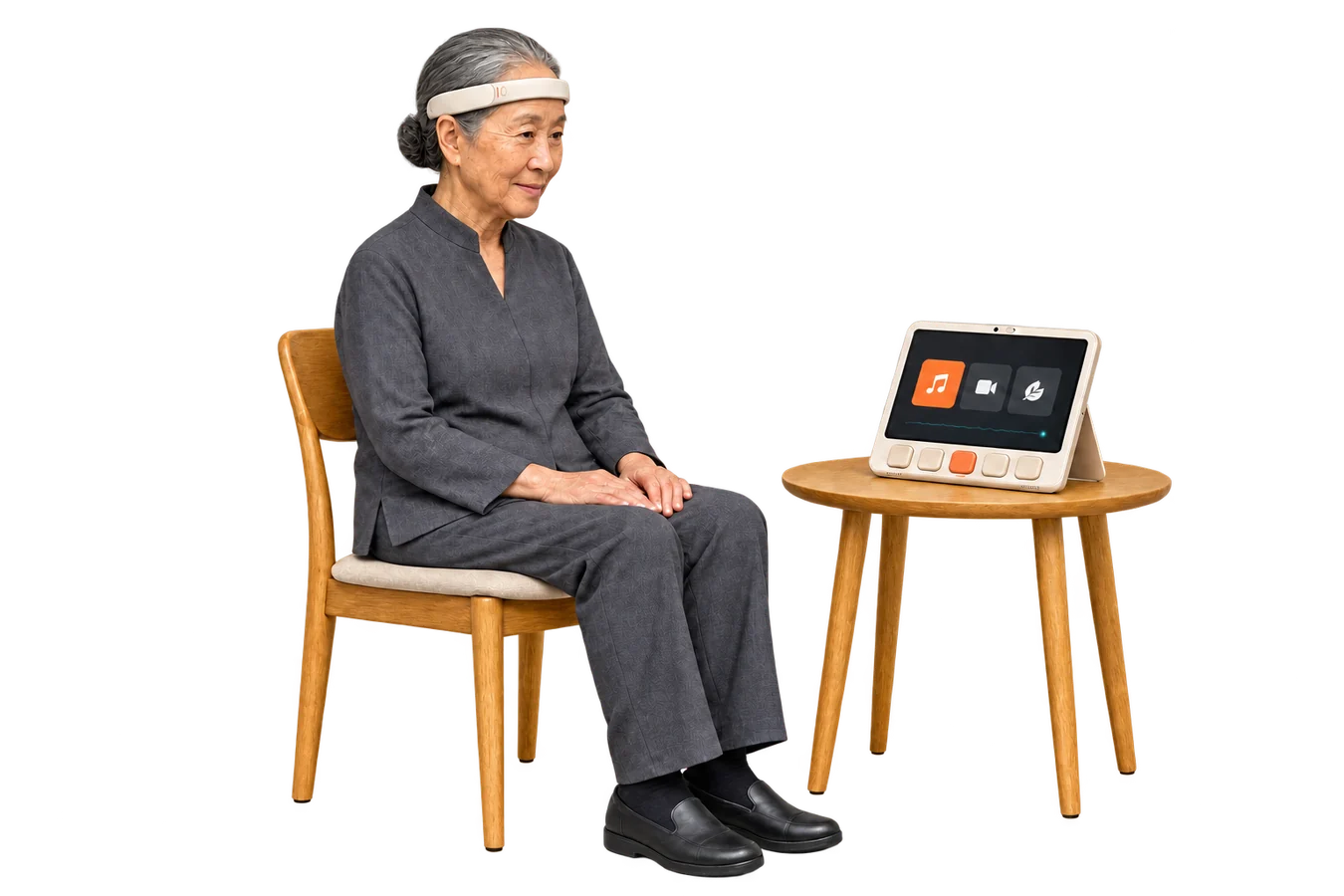 An older Korean woman wearing Brainwear, seated beside her qPad on a small table